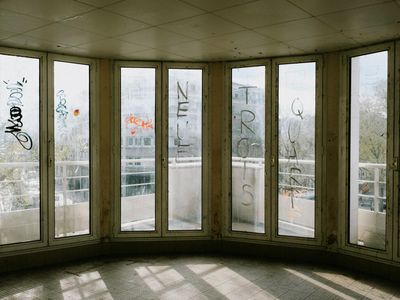 Sunlight streaming through large windows in a gym.